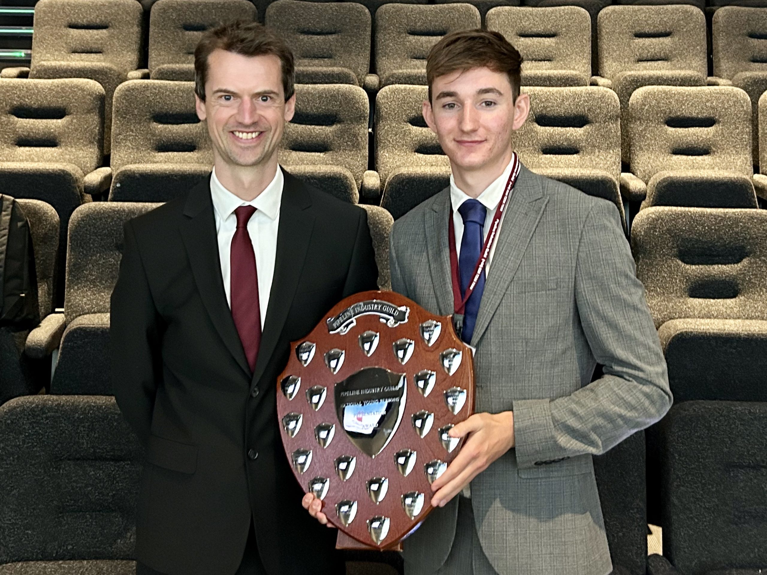 Zac holding his Pipeline Industries Guild Competition award alongside Scottish Water Horizons Mentor, John Lenehan