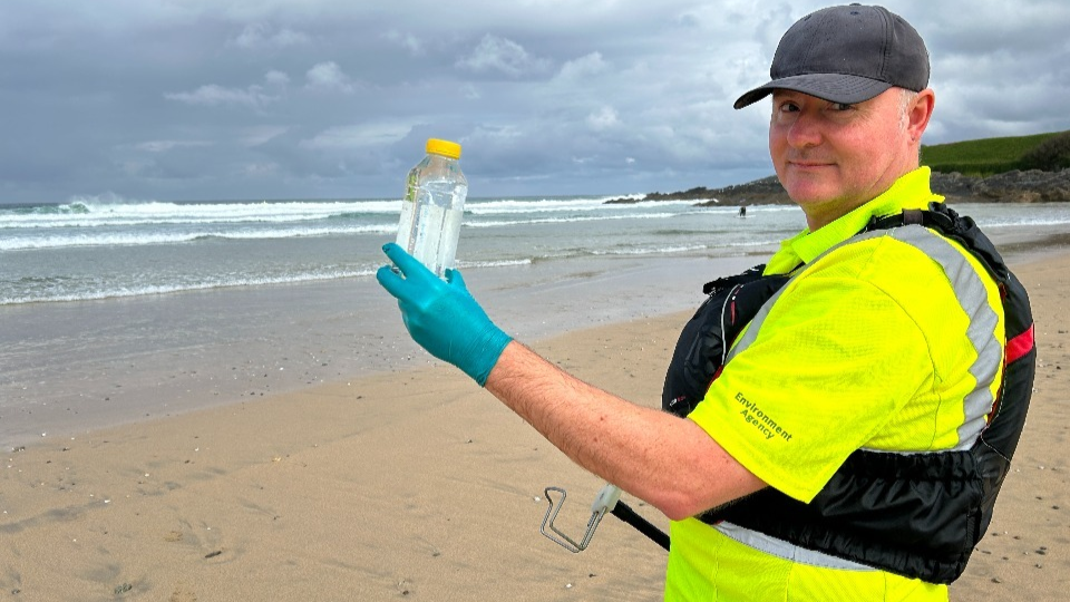 An Environment Agency officer with a fresh sample taken, ready to be sent to the lab for testing